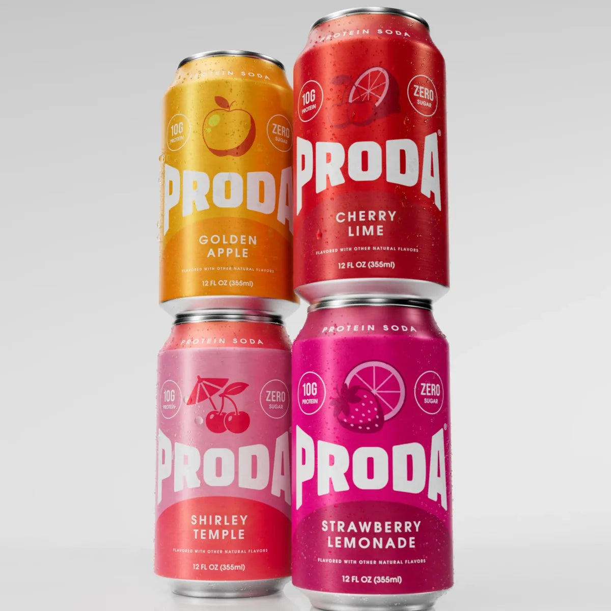 Cans of PRODA Golden Apple and Cherry Lime stacked on Shirley Temple and Strawberry Lemonade
