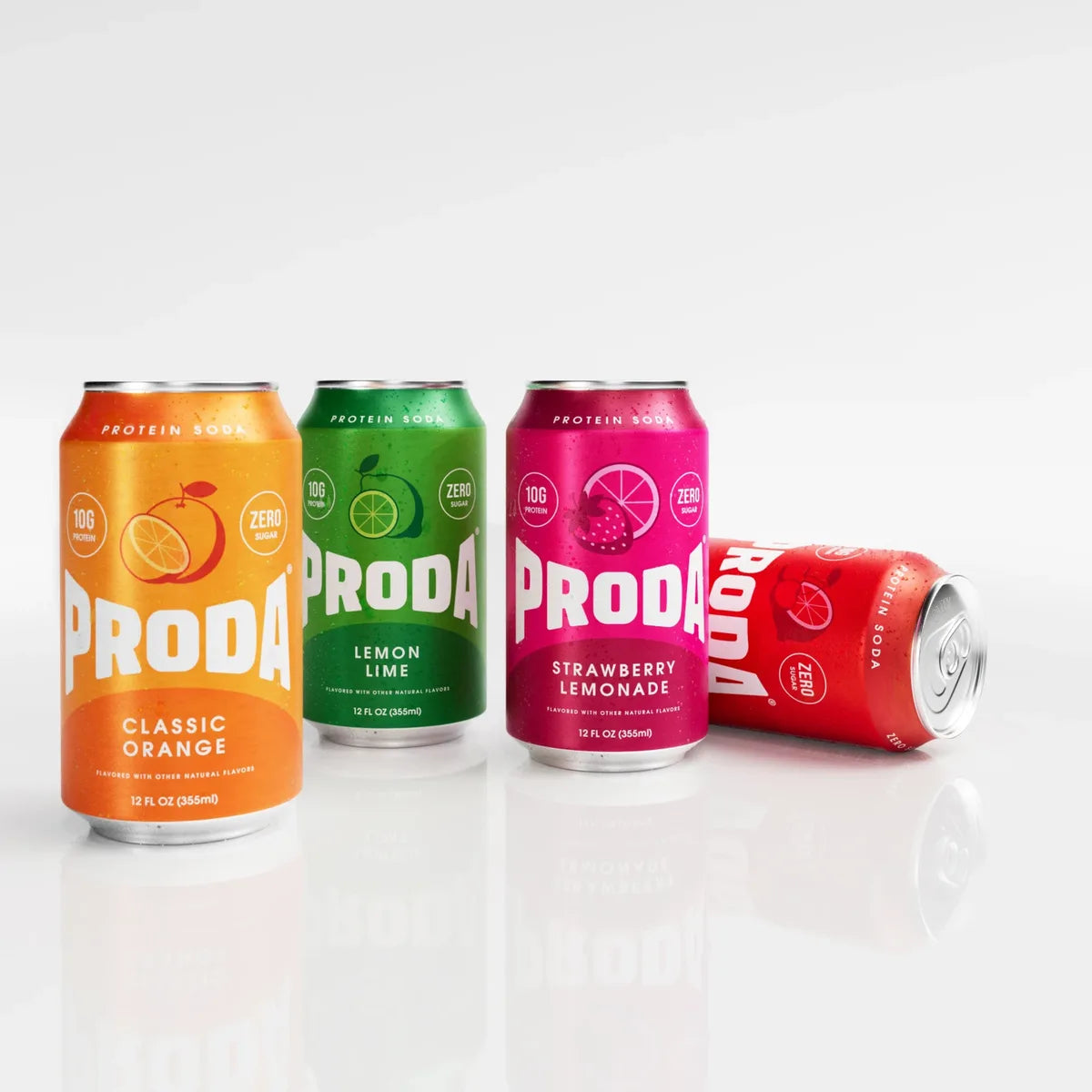 Cans of PRODA Classic Orange, Lemon Lime and Strawberry Lemonade standing, with Cherry Lime on its side