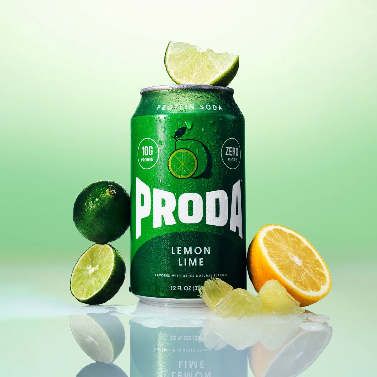 A can of PRODA Lemon Lime with limes and a halved lemon on a soft green backdrop