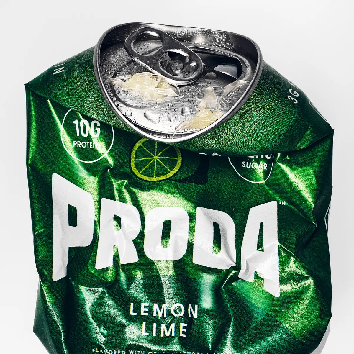 A crushed can of PRODA Lemon Lime on white